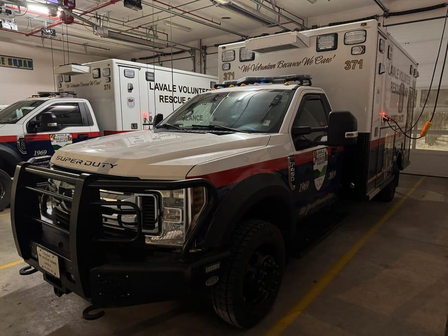 Ambulance 371, a white and red Lifeline ambulance, parked in the station bay